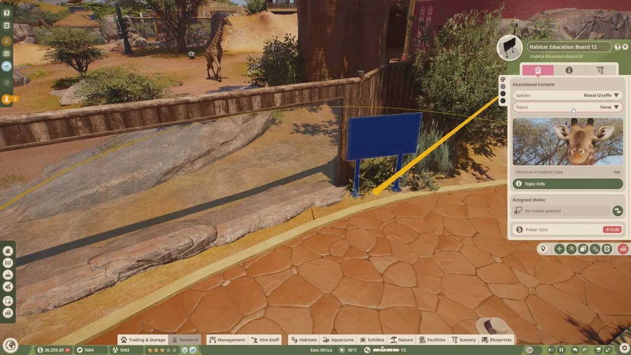 Planet Zoo 2 beginner tips habitat education board settings showing Masai Giraffe species and Topics set to None